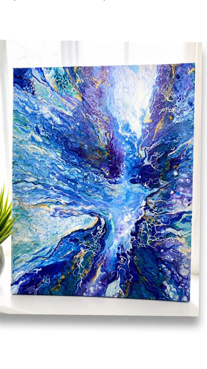 A deep blue acrylic pour on canvas