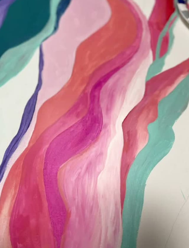 Bands of pink and teal waves painted on canvas